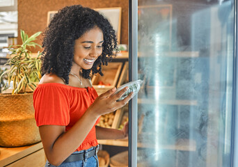 Supermarket, grocery store and customer black woman shopping for healthy food in fridge happy with price discount, sale or promotion. Groceries, small business store and vegan girl with green choice