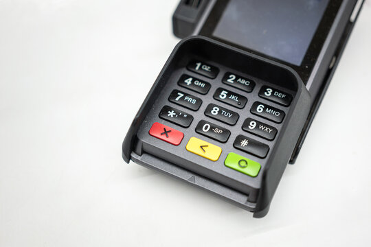 A credit card reader machine at the payment cashier. Financial technology device object photo, selective focus on the number keypad.