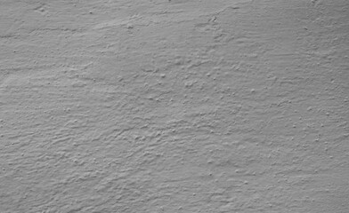 Close-up fragment of a wall with light gray plaster.