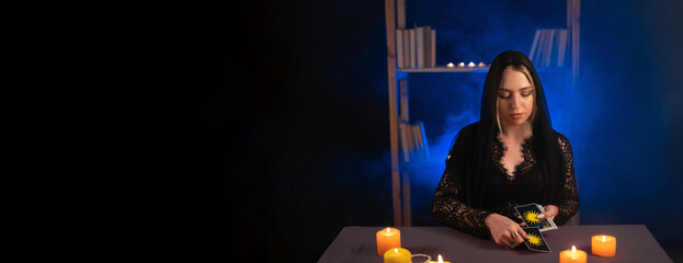 Fortune teller hands and tarot cards on wooden table. Divination