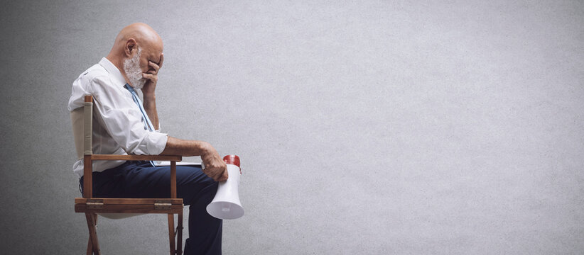 Disappointed film director holding a megaphone