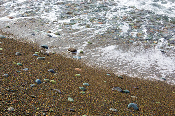 Sea shore. Beach. Pebble. Wave. Surf.