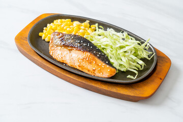 grilled salmon fillet steak on hot plate