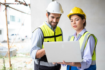 Engineers on building site. Engineer are working contruction on site plans to build high-rise buildings building. Architect caucasian man working with colleagues mixed race in the construction site.
