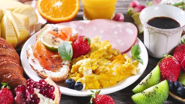 healthy breakfast or brunch with fried egg, toast with salmon, fresh fruit and coffee cup