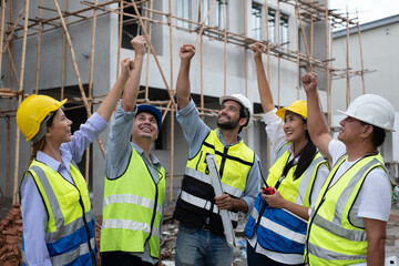 Engineers on building site. Engineer are working contruction on site plans to build high-rise buildings building. Architect caucasian man working with colleagues mixed race in the construction site.