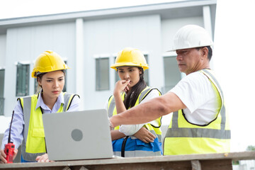 Engineers on building site. Engineer are working contruction on site plans to build high-rise buildings building. Architect caucasian man working with colleagues mixed race in the construction site.