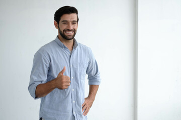 Friendly face portrait of an authentic caucasian bearded man with glasses of toothy smiling dressed casual against a white wall isolated