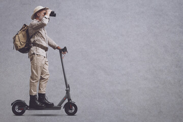 Explorer riding binoculars and riding a scooter