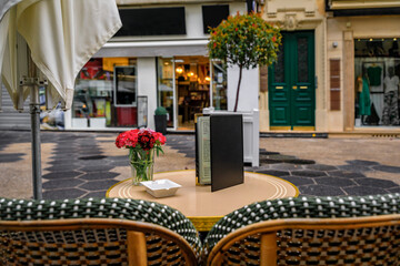 Outdoor table with flowers at a bakery cafe in old town Nice, South of France