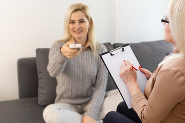 Psychologist comforting a depressed woman during a mental therapy session at the office, lady need of professional help