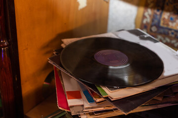 Playing vinyl records. Listening to music from vinyl record player. Retro and vintage music style. Stack of old records. Music collection. Music passion