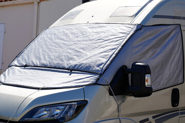 camper with windshield cover for night light protect