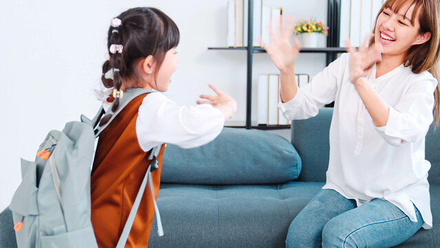 Young Asia Mother Helping Her Daughter Get Ready For School . Asian Kids Student Going First Day At School And Waving Goodbye Mom. Concept Beginning Of Lessons And Helth