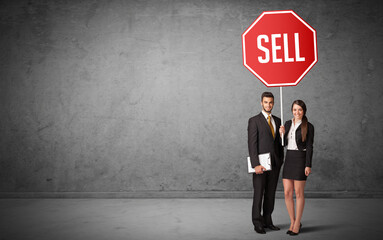 Young business person holding road sign
