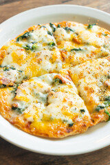 spinach and bacon pizza on plate
