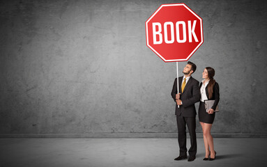 Young business person holding road sign