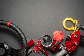 Sport car tuning accessories on the black flat lay background with copy space.