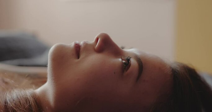 Close-up of woman wake up at early morning open eyes