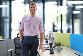 Portrait of a happy young casual businessman at office