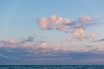 Fototapeta premium Background with lilac sky with dusk cumulus clouds. Horizon. Heaven with cloudscape with copy space. Concept of freedom and tranquil