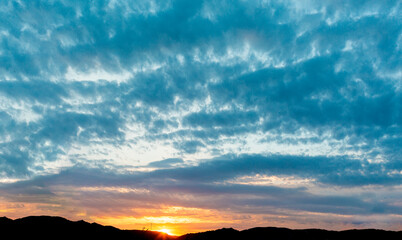 Epic dusk in the sky with clouds. Copy space. Scenic abstract background