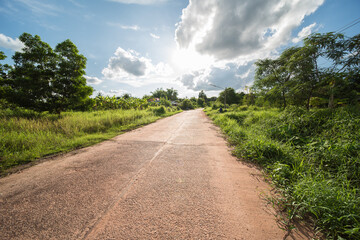 Fototapeta na wymiar road with deep sun and clouds in the province of udon thani in thailand.