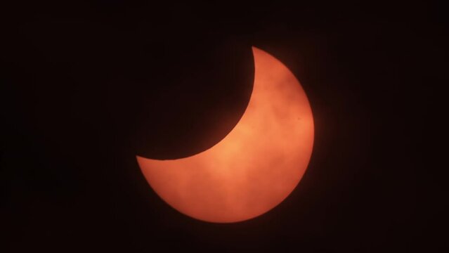 Partial Solar Eclipse When Sun Rise in Europe October 25, 2022. Movement of Clouds in Front of Sun During a Solar Eclipse. Moon Cast Shadows Covering During Partial Solar Eclipse With Clouds Moving. 