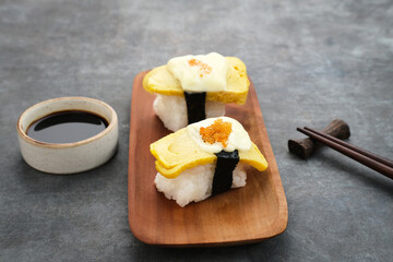 Egg Sushi Rolls or tamago sushi with red caviar, Japanese food
