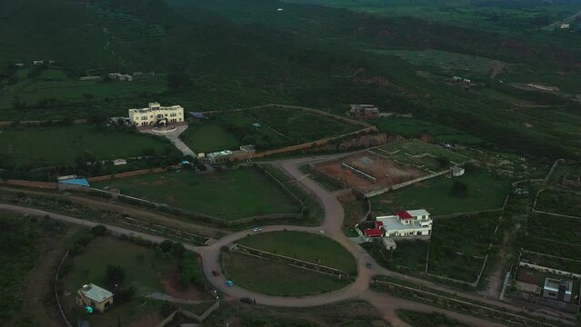 Aerial footage of the Margalla Hills with roads and buildings in Islamabad, Pakistan