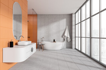 Bright bathroom interior with sink and tub near panoramic window