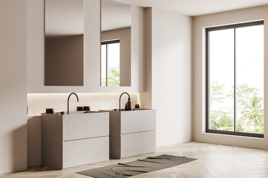 Stylish bathroom interior with two washbasins and mirror, panoramic window