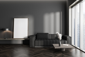 Dark living room interior with sofa, empty white poster