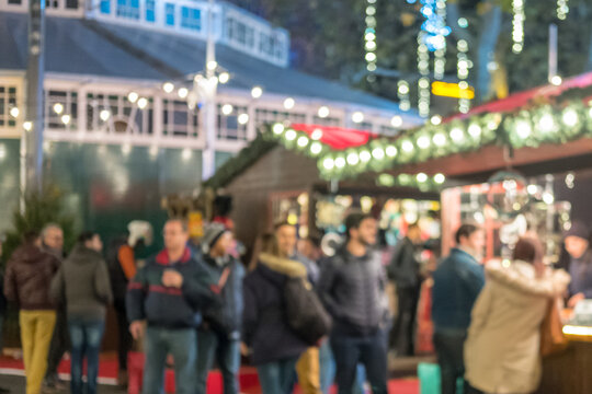 Blurred image bokeh of People walking, shopping at Christmas Market in Leicester Square, London.