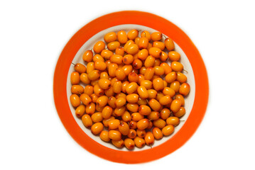 A plate with sea buckthorn berries. Flat lay.