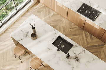 Top view of light kitchen interior with bar countertop, kitchenware and window