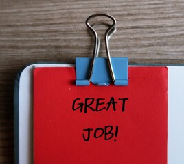 Office red note clip on document with handwriting GREAT JOB!, compliment team or workers for the...