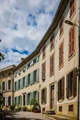 Fototapeta na wymiar Street and house facades in the medieval village of Fanjeaux in the South of France (Aude)