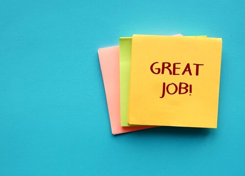 Note pad on blue background with handwritten text GREAT JOB!, concept of compliment to praise someone  they are doing well done job or awesome work, positive self talk  to boost self esteem