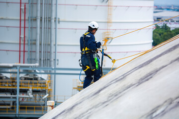Male workers clear rope access wearing safety first harness rope safety line