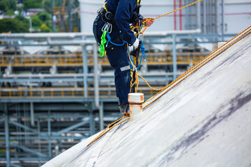 Male workers clear rope access wearing safety first harness rope safety line