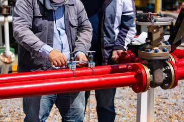 Male worker test ultrasonic flowing fire water hydrant pipes are installed flow rate test devices to measure