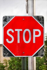 Vertical closeup of a red "stop" road sign