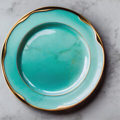 Turquoise plate porcelain with gold border on marble table. Empty dishes. Modern utensils. View from above. Top view of empty saucer