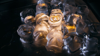Close-up of wedding rings on ice cubes