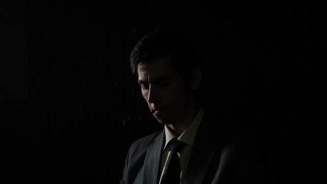 A serious young man smoking a pipe, a man in a gray suit with a tie, deep shadows in a retro noir style