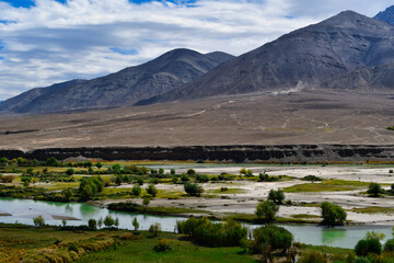 Fototapeta na wymiar Sangam is the point where the rivers Indus and Zanskar join together - the green hues of Indus clashing with the muddy blue stream of ZanskarMagnet Hill is a gravity hill located near Leh in Ladakh.