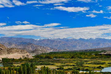 Fototapeta na wymiar Sangam is the point where the rivers Indus and Zanskar join together - the green hues of Indus clashing with the muddy blue stream of ZanskarMagnet Hill is a gravity hill located near Leh in Ladakh.