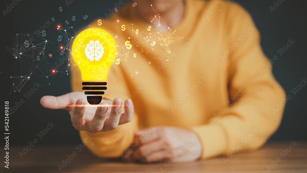 Poster man holding a glowing abstract light bulb on a wooden table, business problem solving ideas and crea