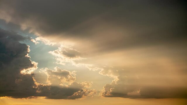Timelapse of beautiful clouds and rays of the setting sun at sunset